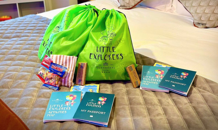 image of kids green goody bag set on hotel bed